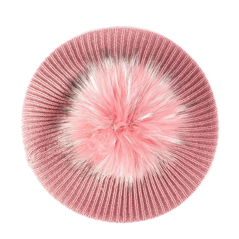 Pink knitted beret with pompom.