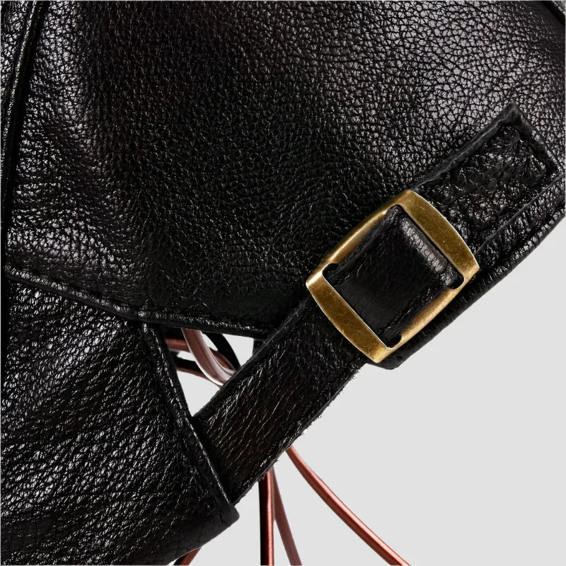 Black leather bag with brass buckle.