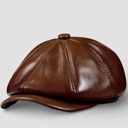 Brown leather newsboy hat with six-panel design and curved brim