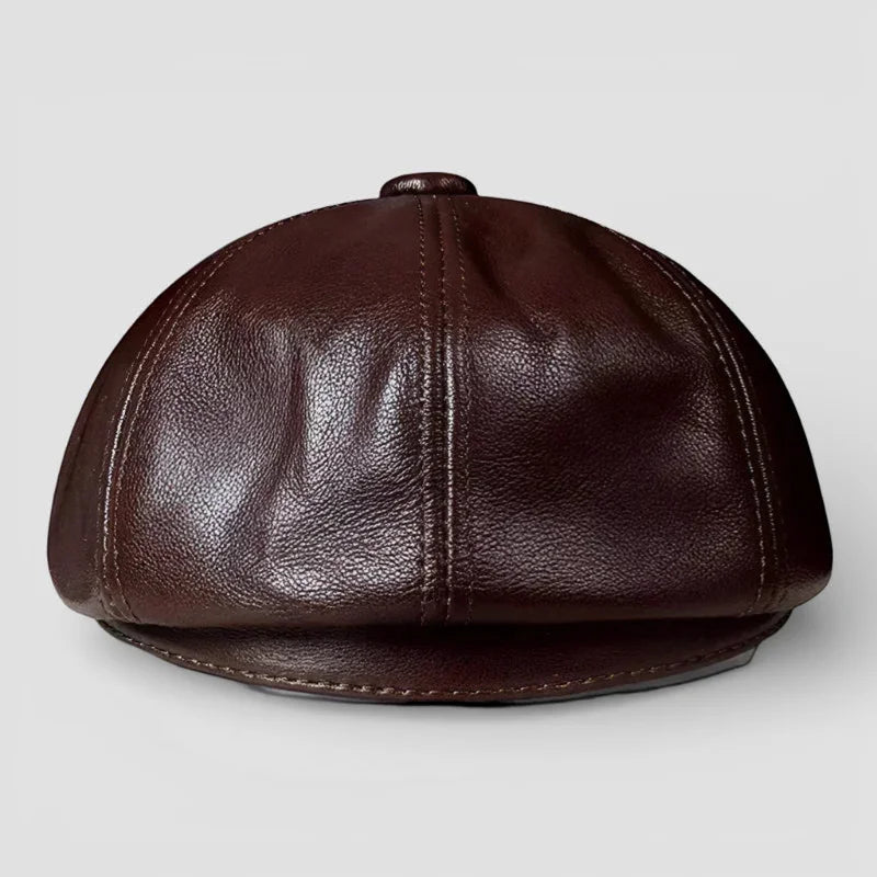 Rich brown leather newsboy hat with eight-panel design and visible stitching