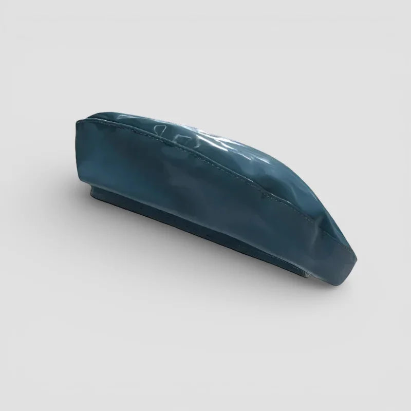 Sleek leather turquoise beret with glossy teal finish and curved brim
