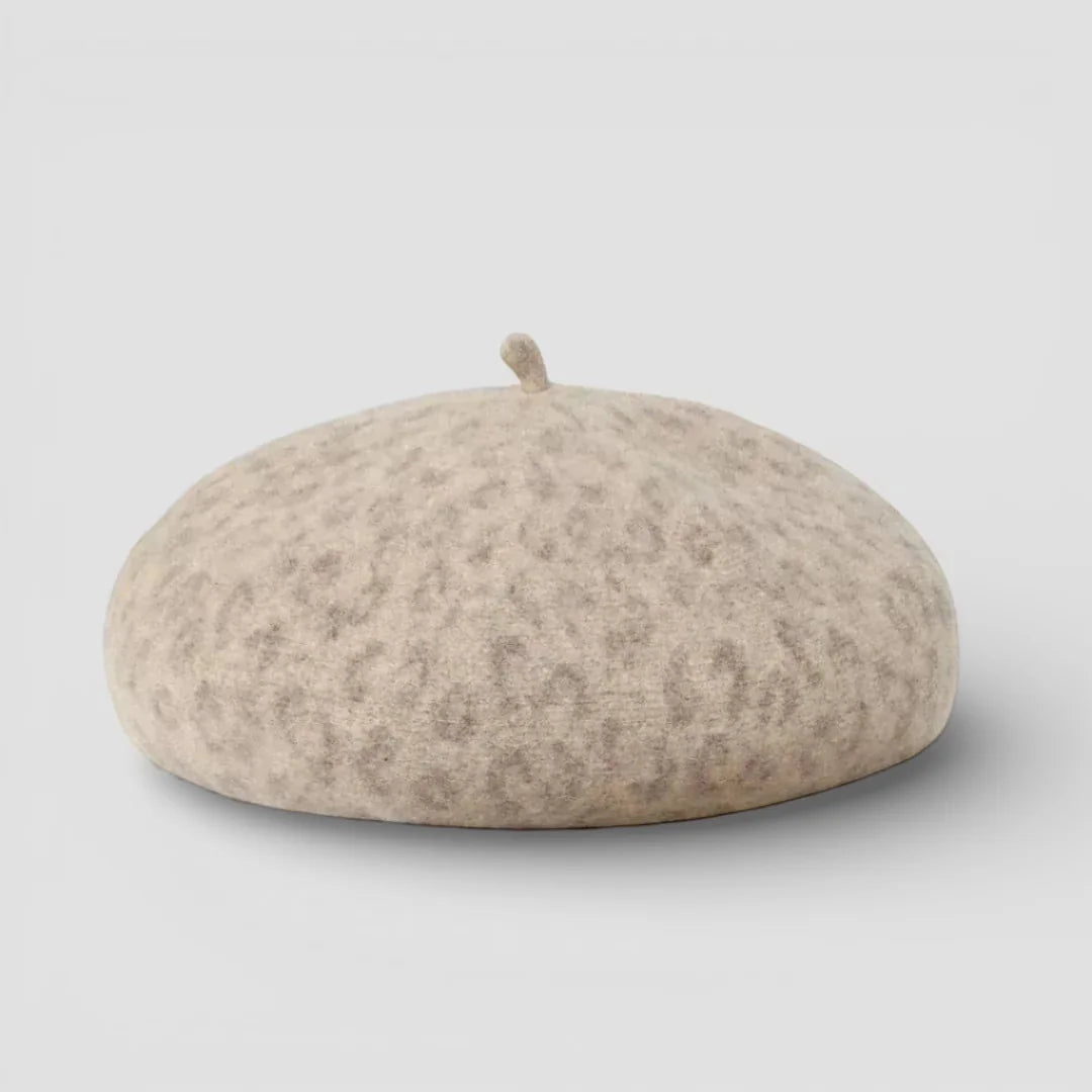 Beige leopard-print beret with soft textured fabric and top button