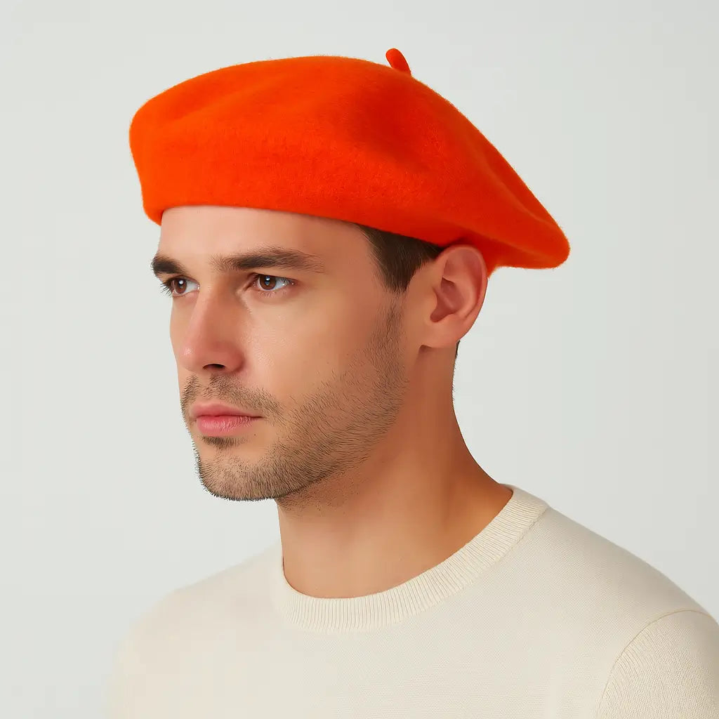 Man wearing a bright orange beret against a plain background