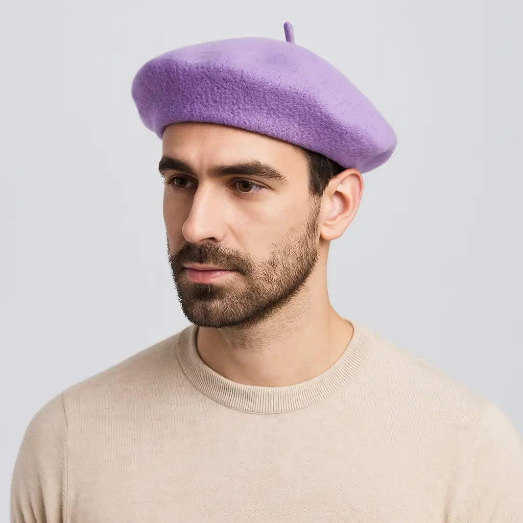 Man wearing a purple beret against a light gray background