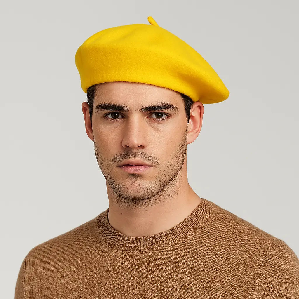 Man wearing a yellow beret against a gray background