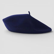 Sleek navy blue beret with soft felt-like texture and rounded top