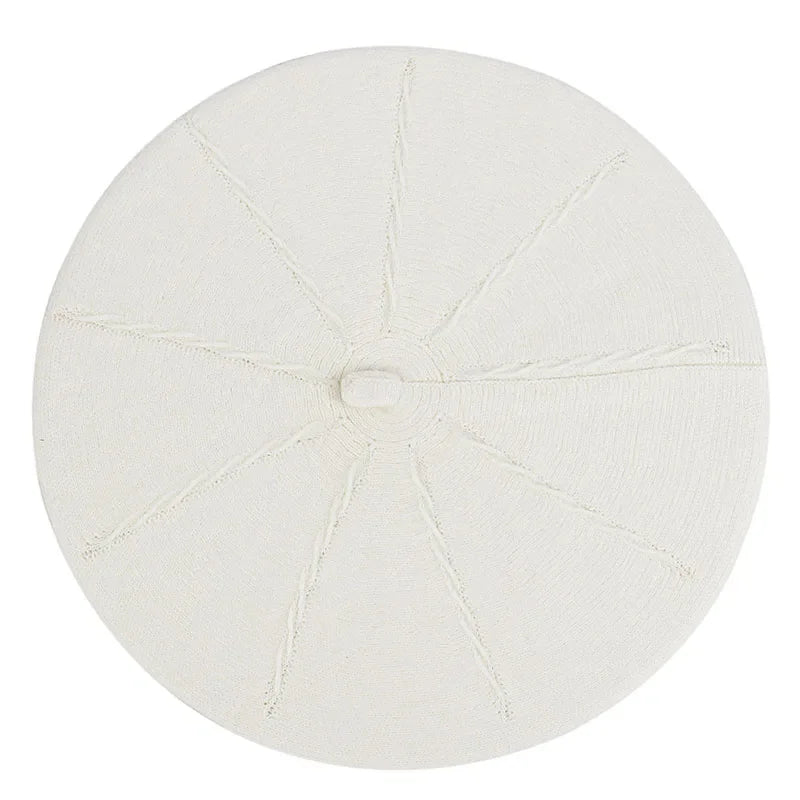 White beret with segmented design.