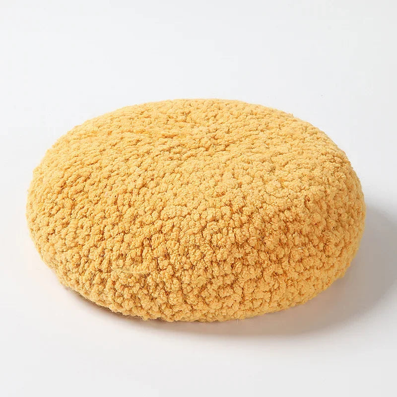 Round, textured, yellow cushion.