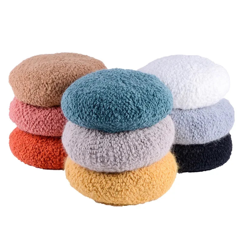 Stacks of colorful, textured berets.