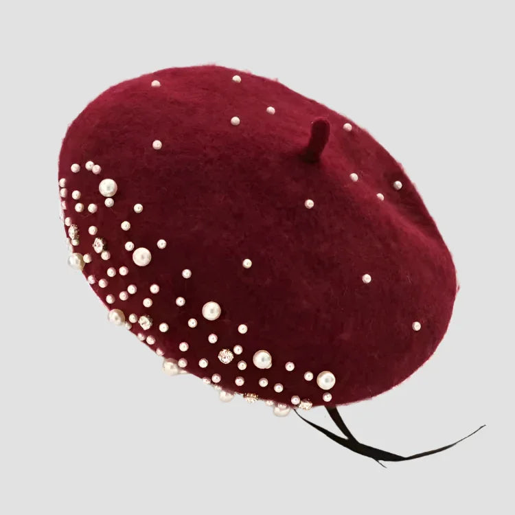 Maroon beret with pearl embellishments.