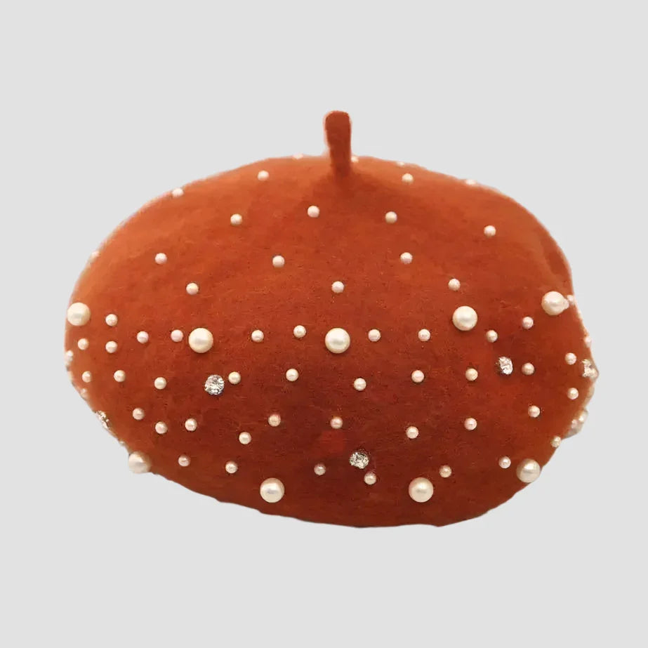 Rust-colored beret with pearl and rhinestone embellishments.