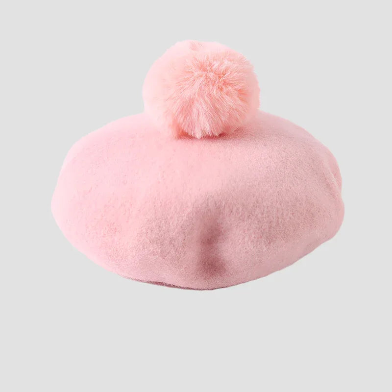 Pink fuzzy beret with pompom.