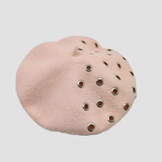 Pink beret with grommets.