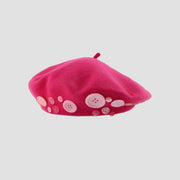 Pink beret with buttons.