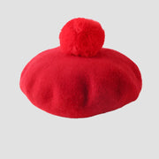 Red beret with pompom.