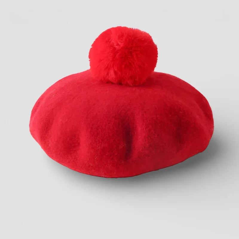 Vibrant red felt beret with matching fluffy pom-pom on top