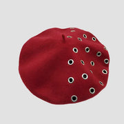 Red beret with grommets.