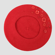 Red beret with buttons.