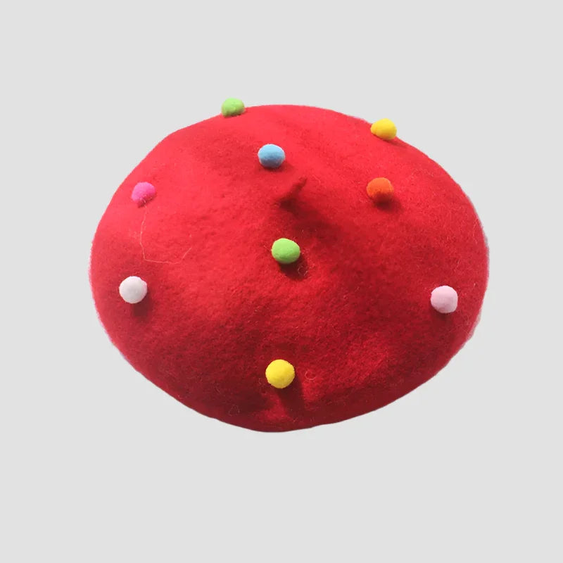 Red beret with colorful pom-poms.