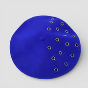 Vibrant royal blue suede beret with asymmetrical silver grommets