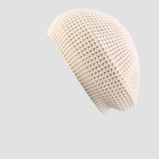 Cream-colored knitted beret.
