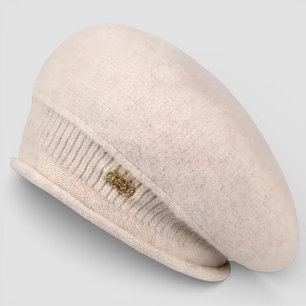 Slouchy wool beret in soft cream with ribbed brim and gold ornament