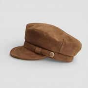 Tan suede newsboy cap with matching band and metallic button