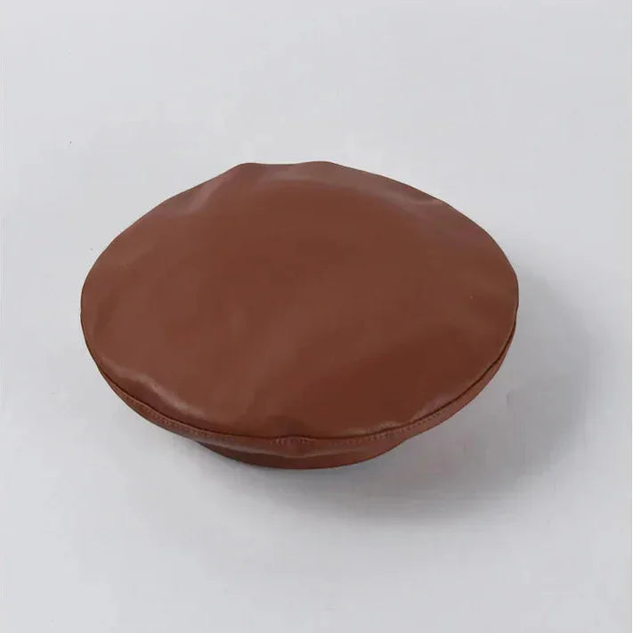 Tan leather beret with brown leather-like glossy finish and subtle brim stitching