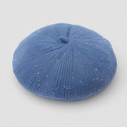 Velvet Beret blue textured sand dollar-shaped object with glittery finish