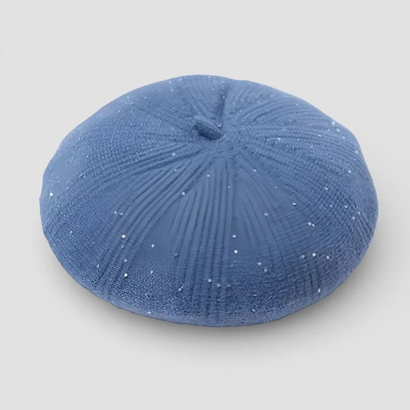 Velvet Beret blue textured sand dollar-shaped object with glittery finish