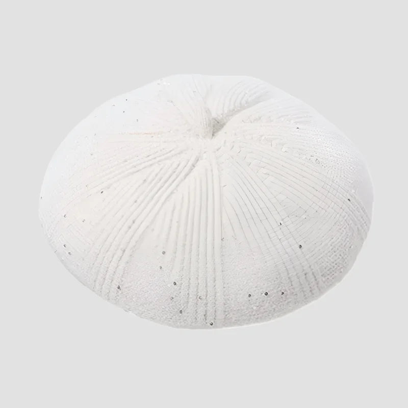 White sand dollar with radial grooves.
