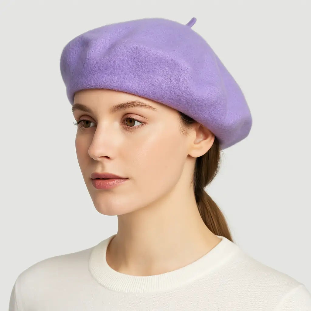 Woman wearing a purple beret against a light gray background