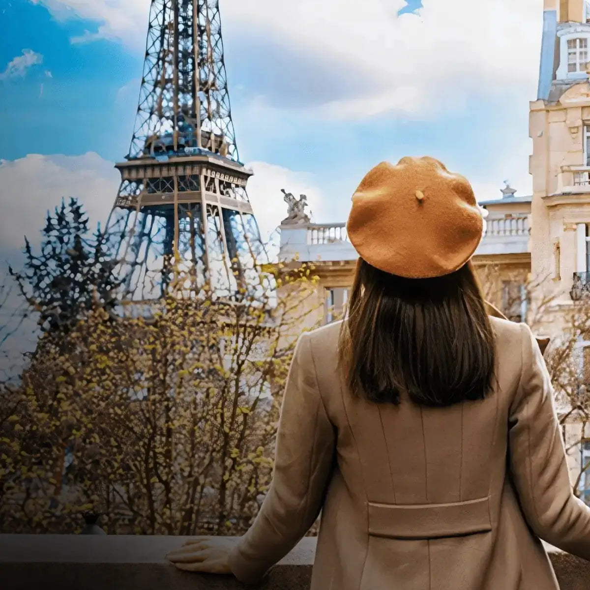 A woman in a brown beret gazes at the Eiffel Tower, her back turned to the camera in a classic Parisian scene.