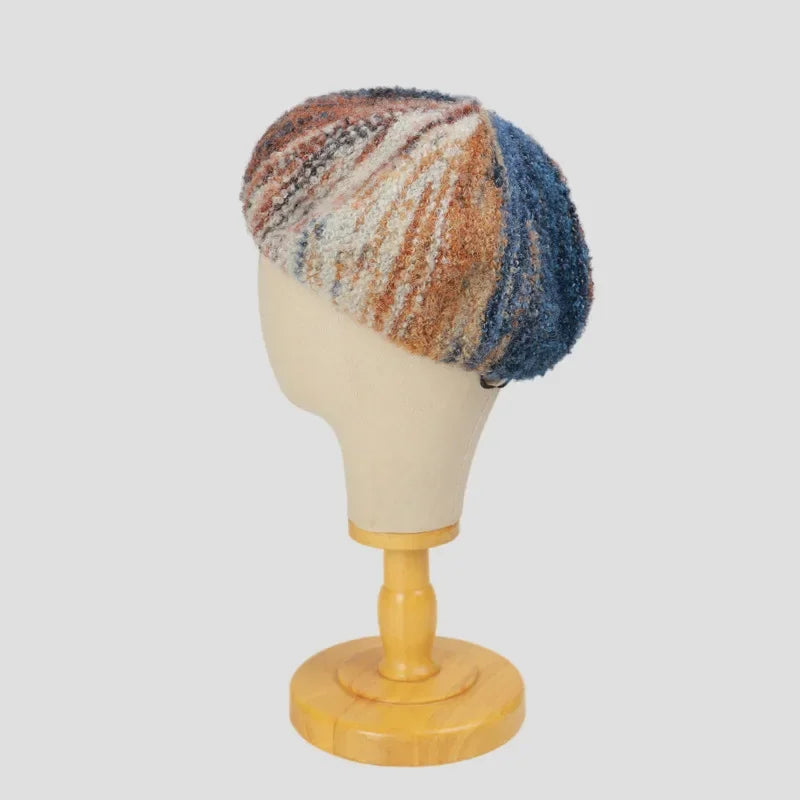 Colorful knit beret on mannequin head.