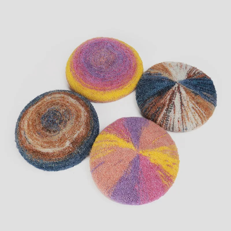 Four colorful, round, knitted berets.