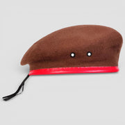 Brown wool beret with red felt trim and black eyelets