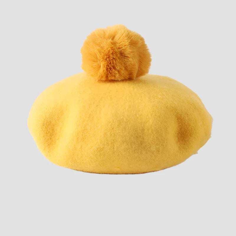 Yellow beret with a fluffy pompom.