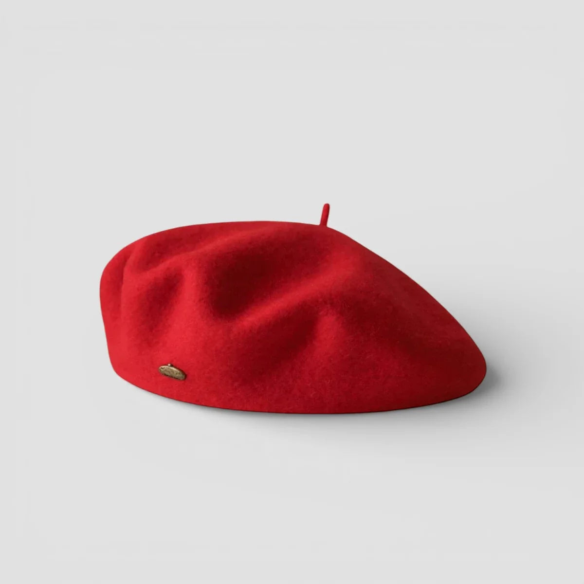 Vibrant red wool beret for women with gold emblem and top button