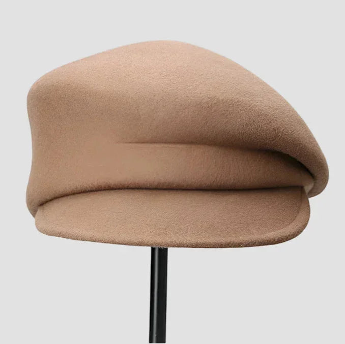 Beige wool newsboy cap beret with soft textured surface and rounded crown