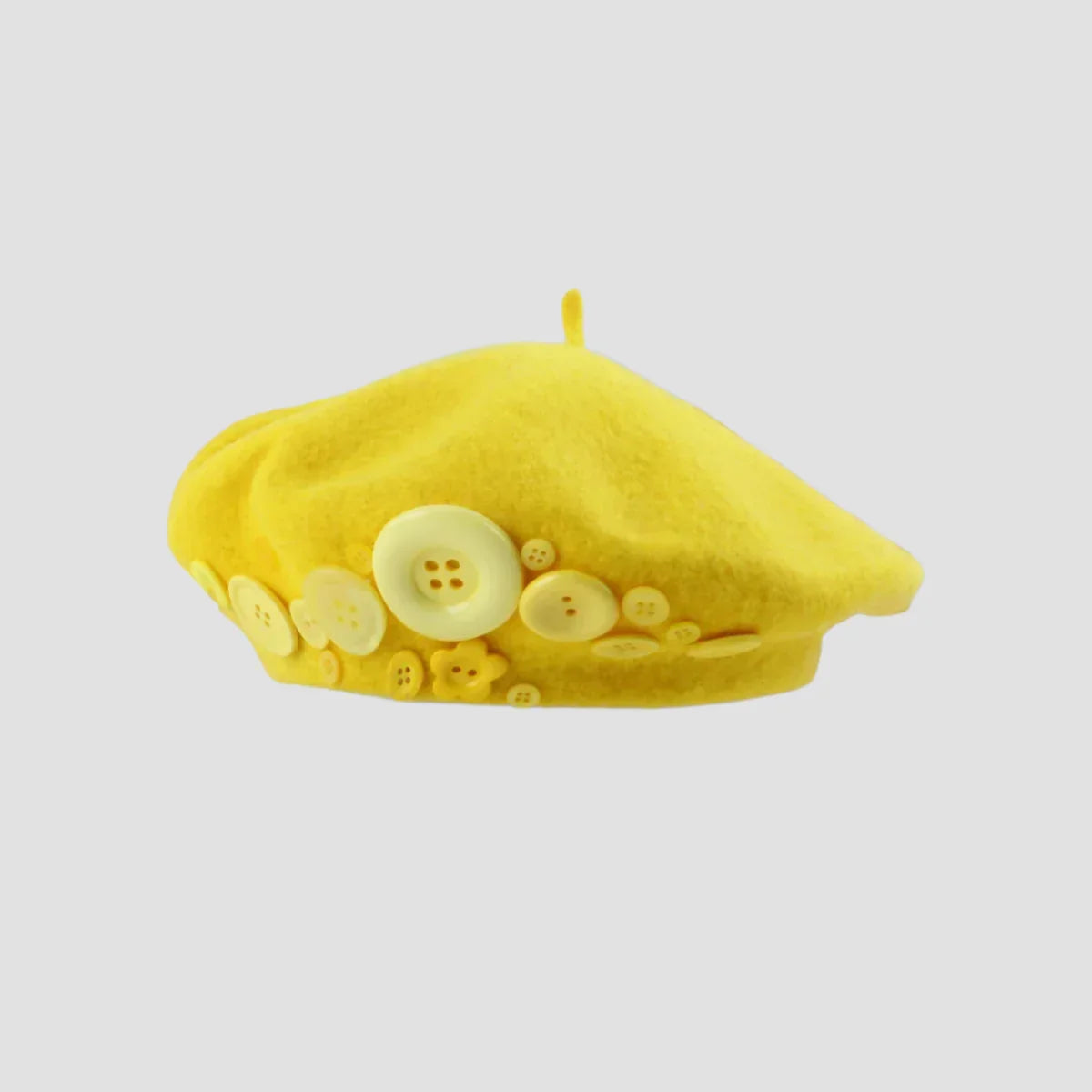 Yellow beret with buttons.